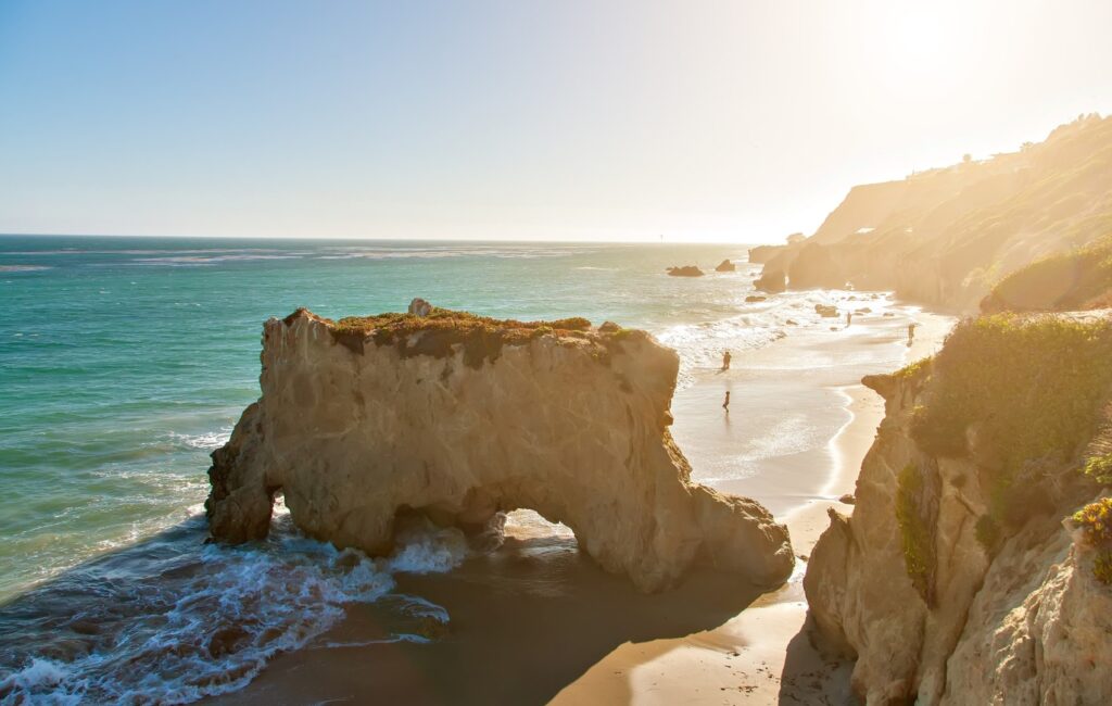 Dramatic rock formations and sea caves along El Matador Beach in Malibu, California.